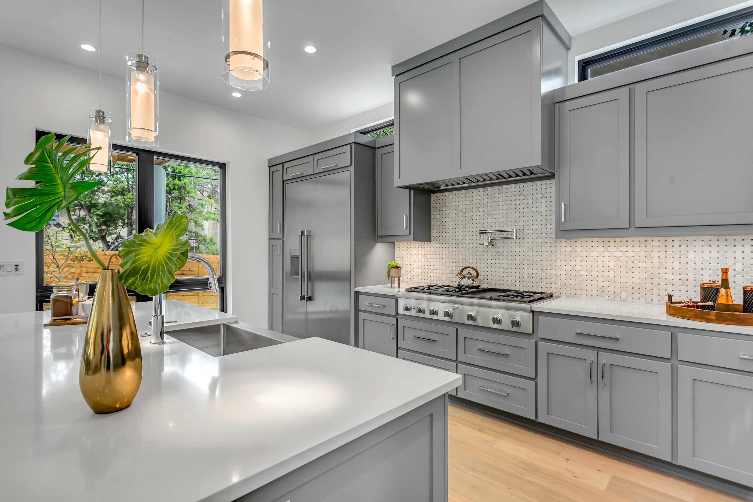 light gray kitchen cabinet with black countertops