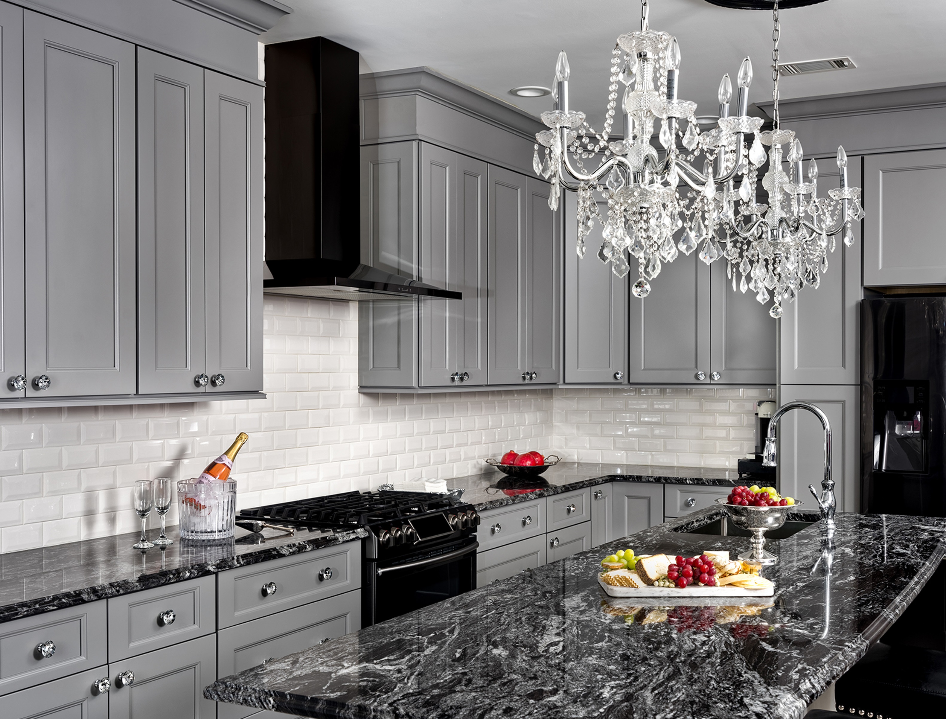 light gray kitchen cabinet with black countertops